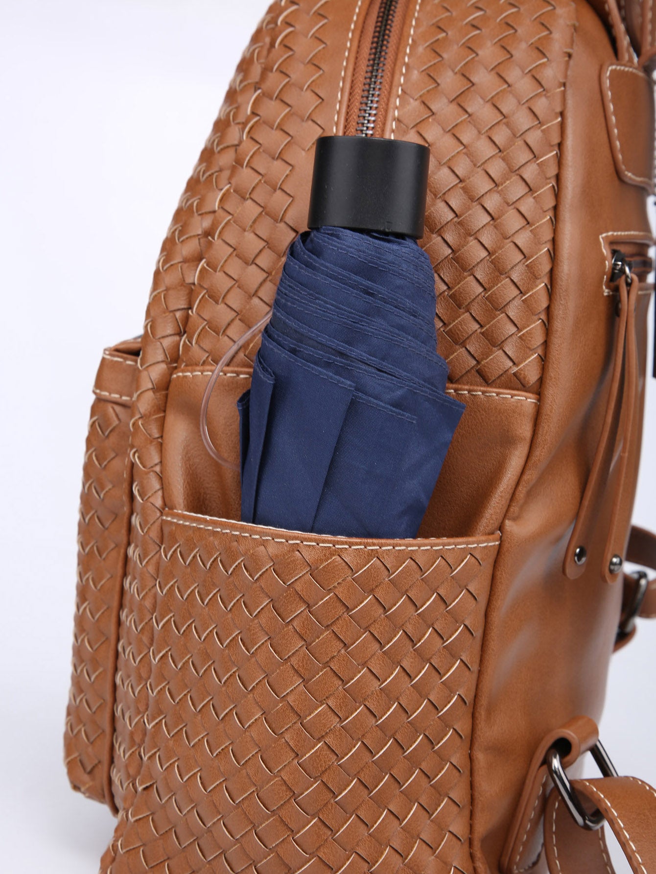 Stylish brown woven backpack purse for women made from vegan leather, showcasing intricate handmade craftsmanship.