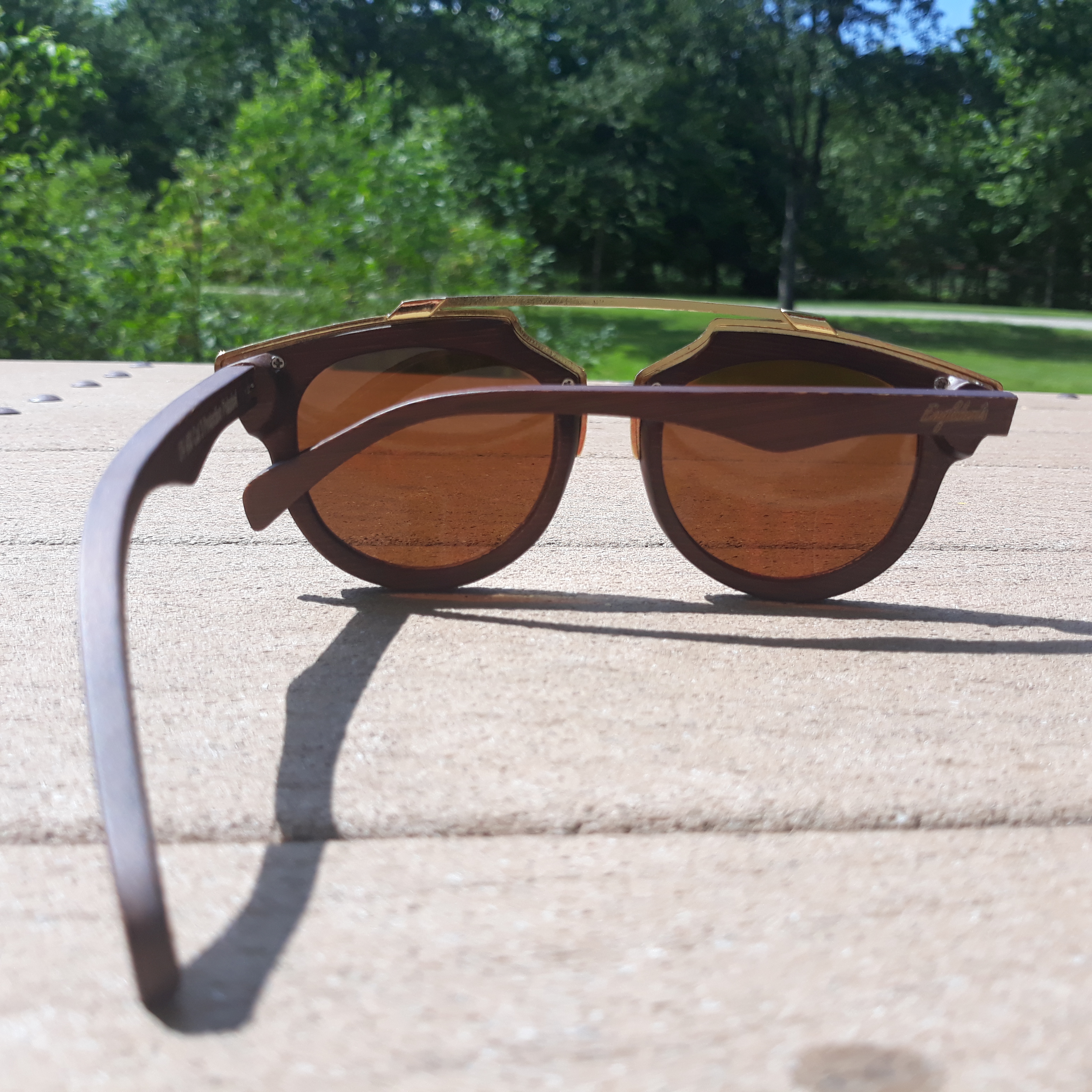 Engleberts Cherry Wood Full Frame sunglasses with polarized lenses and gold trim, displayed in a bamboo case.