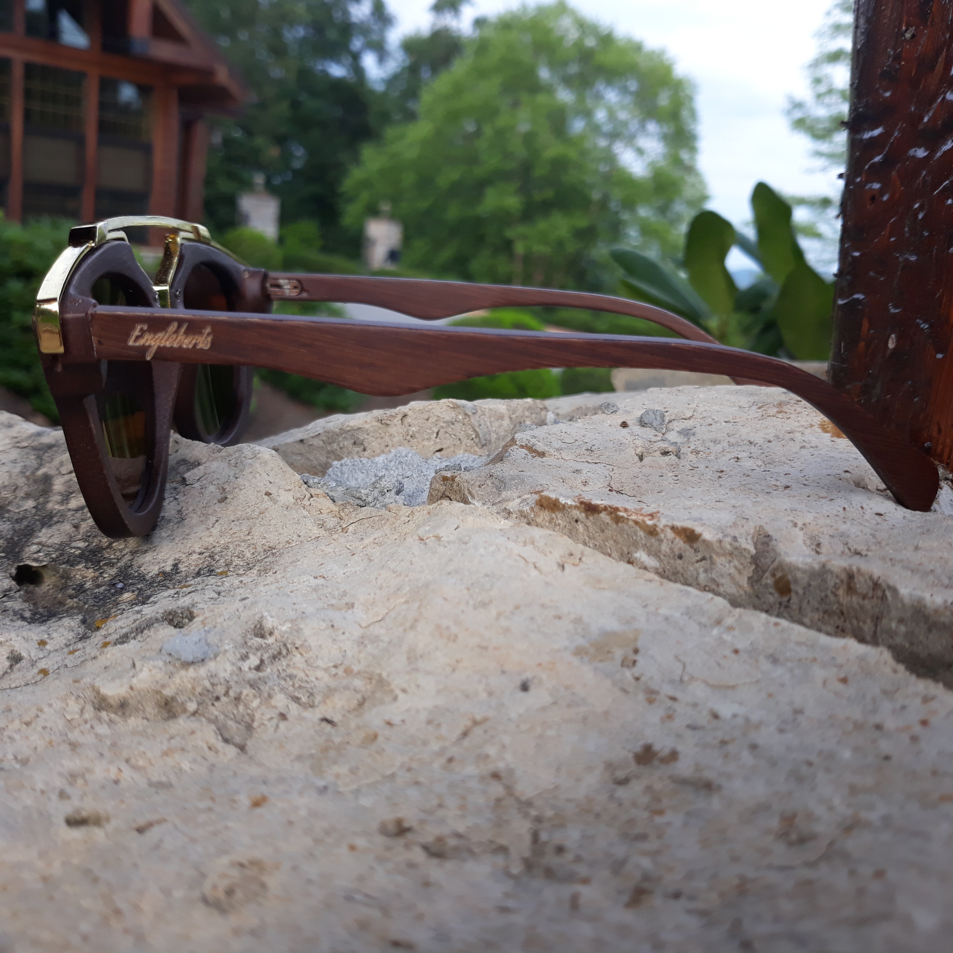 Engleberts Cherry Wood Full Frame sunglasses with polarized lenses and gold trim, displayed in a bamboo case.