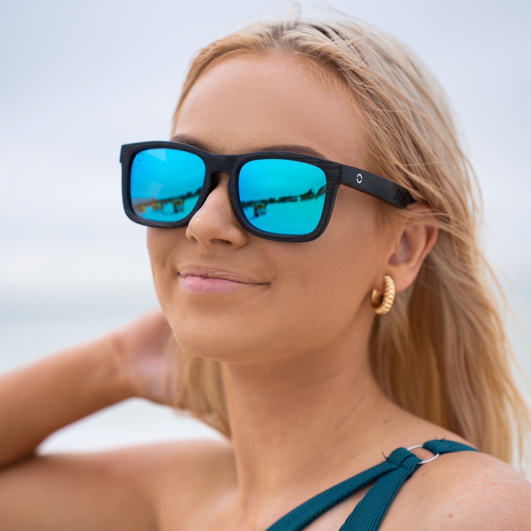 Classic Ocean Breeze sunglasses featuring a black bamboo frame and TAC polarized blue revo lenses, designed for comfort and UV protection.