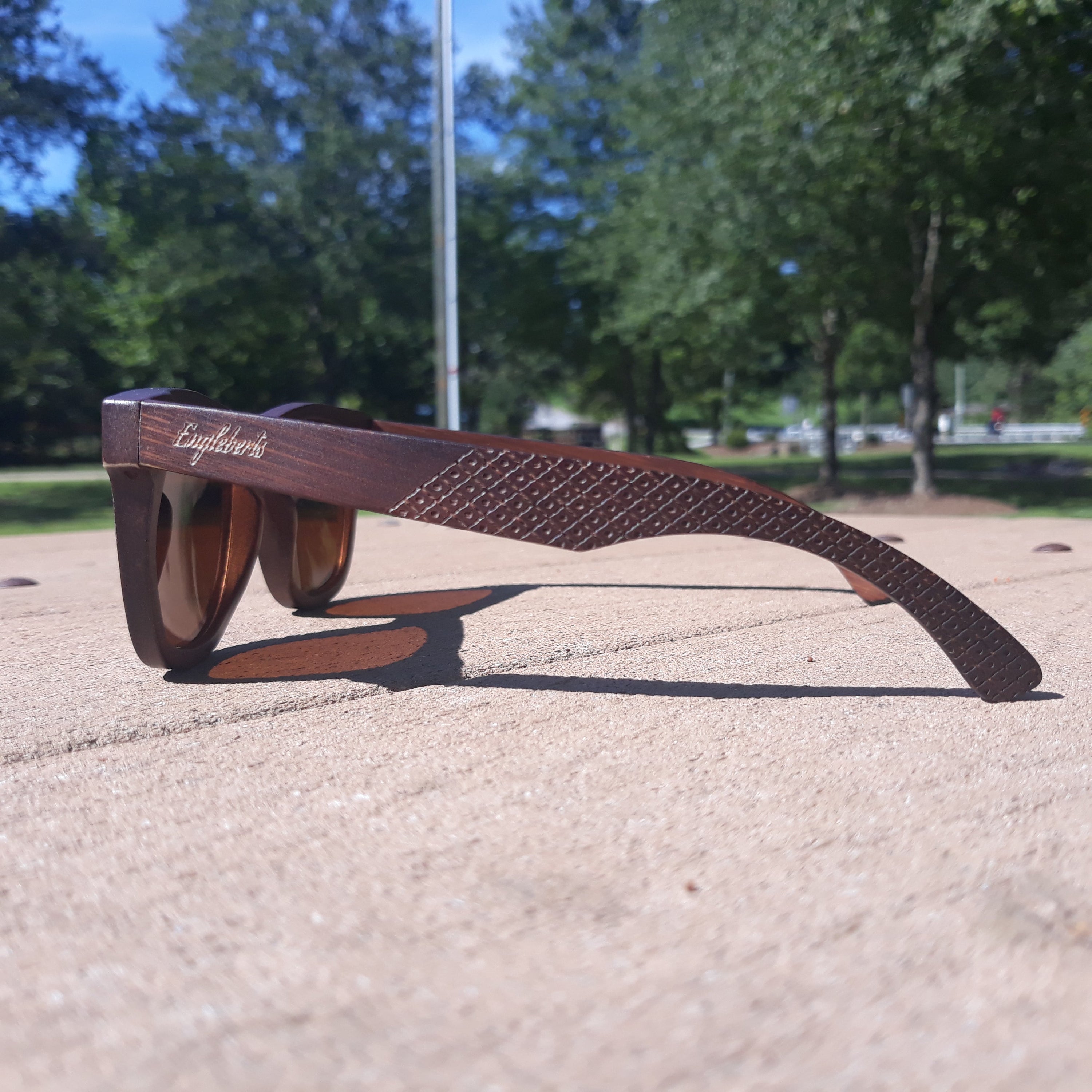 Engleberts Crimson Wooden Sunglasses with tea-colored polarized lenses, showcasing handcrafted wooden frame and stylish design.