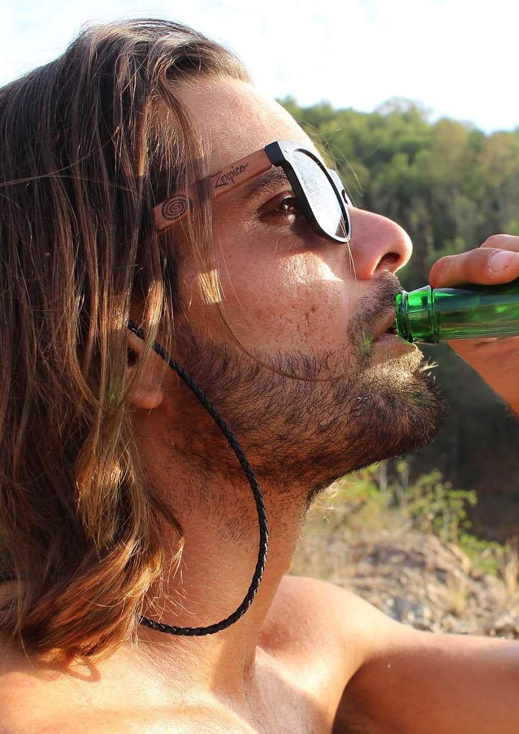 Eyewood engraved wooden sunglasses made from rosewood, featuring a Nazca pattern design on the temples, with polarized black mirror lenses.