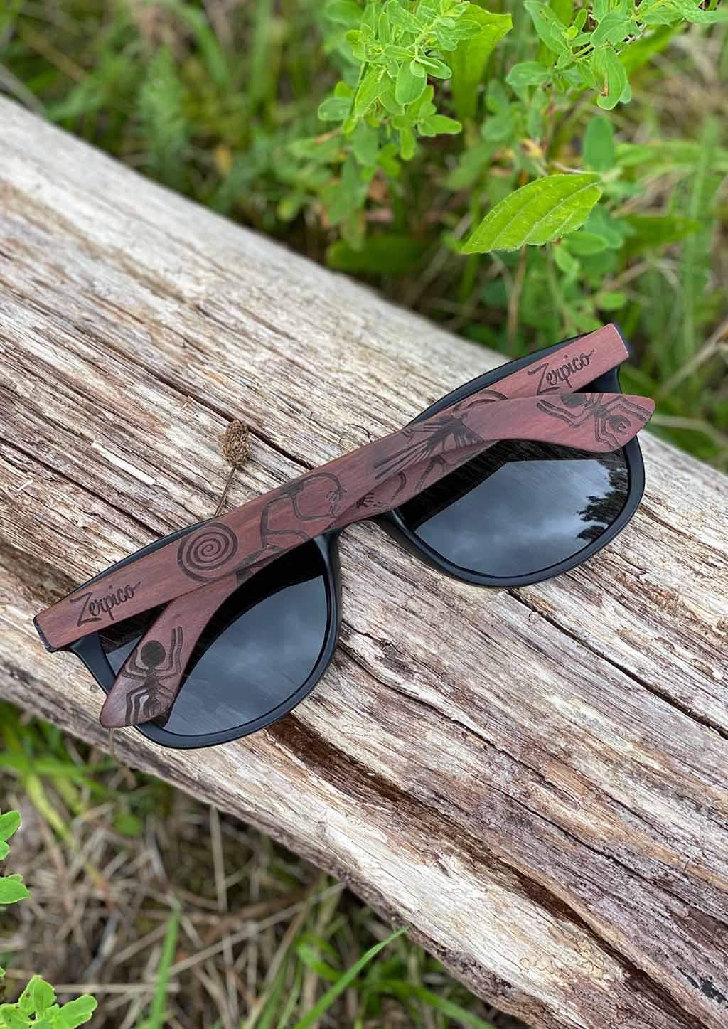 Eyewood engraved wooden sunglasses made from rosewood, featuring a Nazca pattern design on the temples, with polarized black mirror lenses.