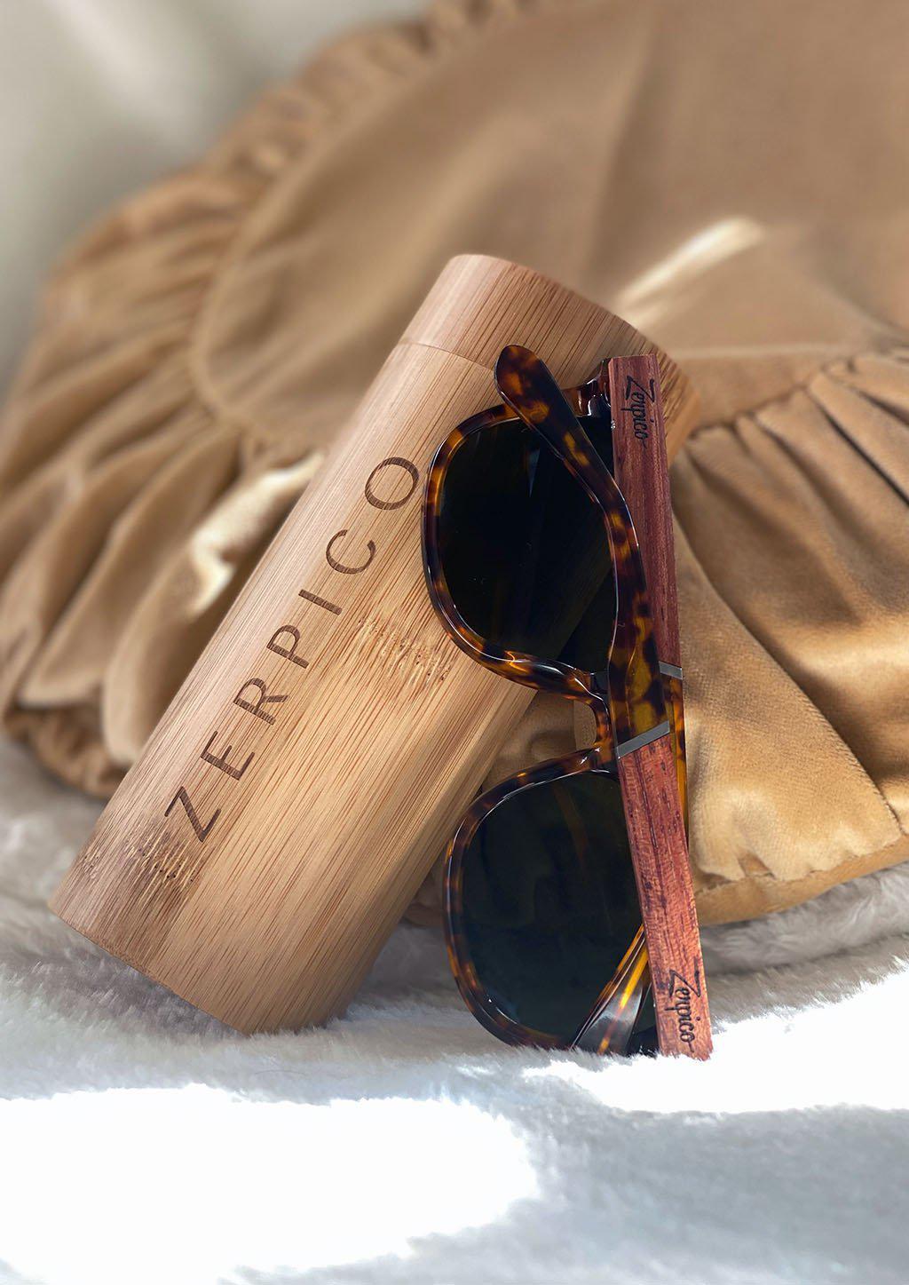 Eyewood Fusion Lynx wooden sunglasses in a round wooden case, showcasing unique design and eco-friendly materials.