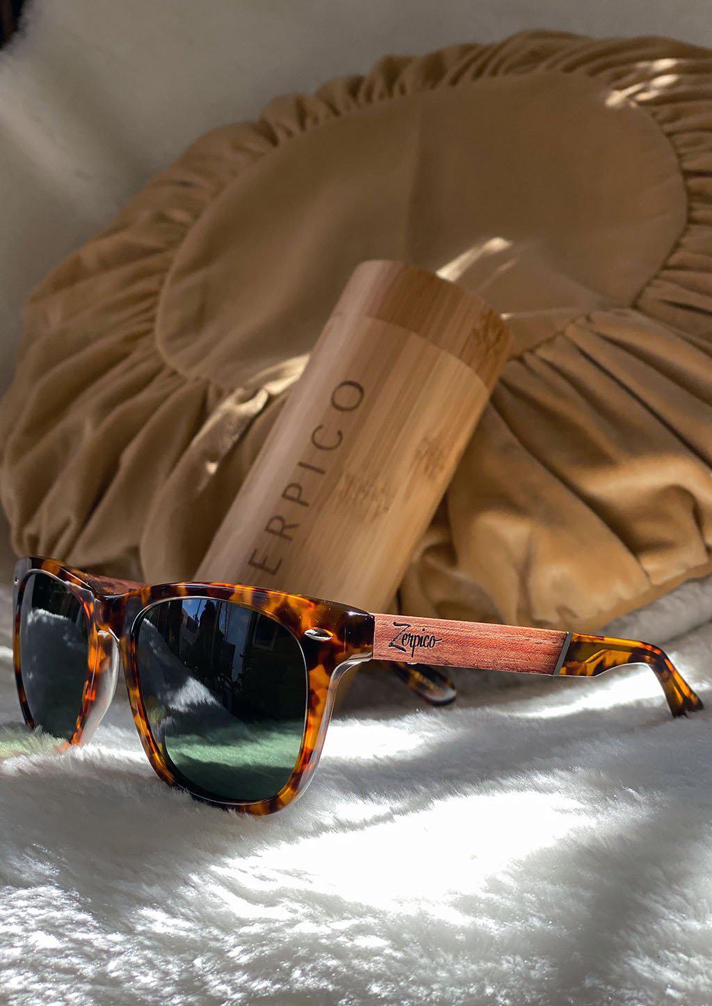 Eyewood Fusion Lynx wooden sunglasses in a round wooden case, showcasing unique design and eco-friendly materials.