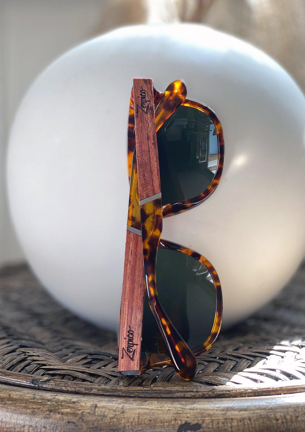 Eyewood Fusion Lynx wooden sunglasses in a round wooden case, showcasing unique design and eco-friendly materials.