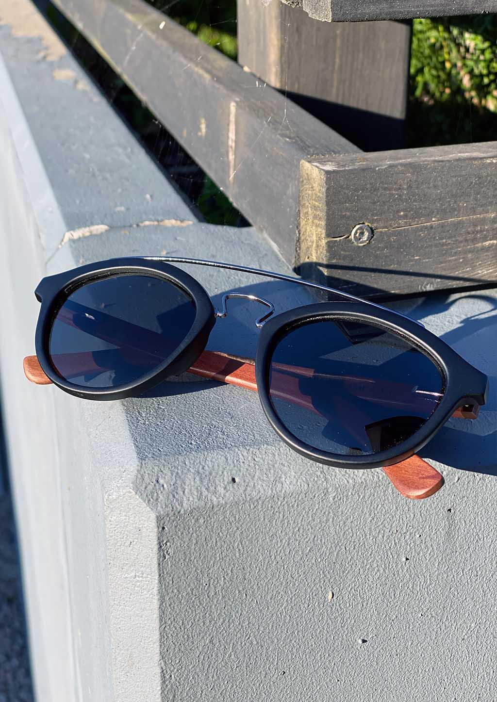 Eyewood Round - Lyric handmade wooden sunglasses featuring polarized grey lenses and unique rosewood design.