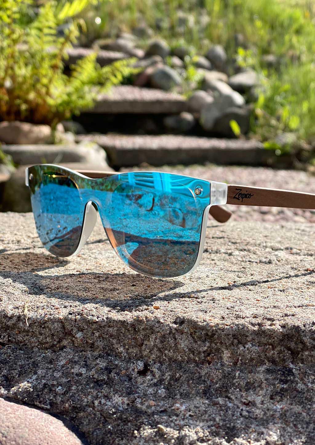 Eyewood Tomorrow - Gemeni wooden sunglasses featuring blue mirror polarized lenses and rosewood frame, displayed in an elegant empress tree case.