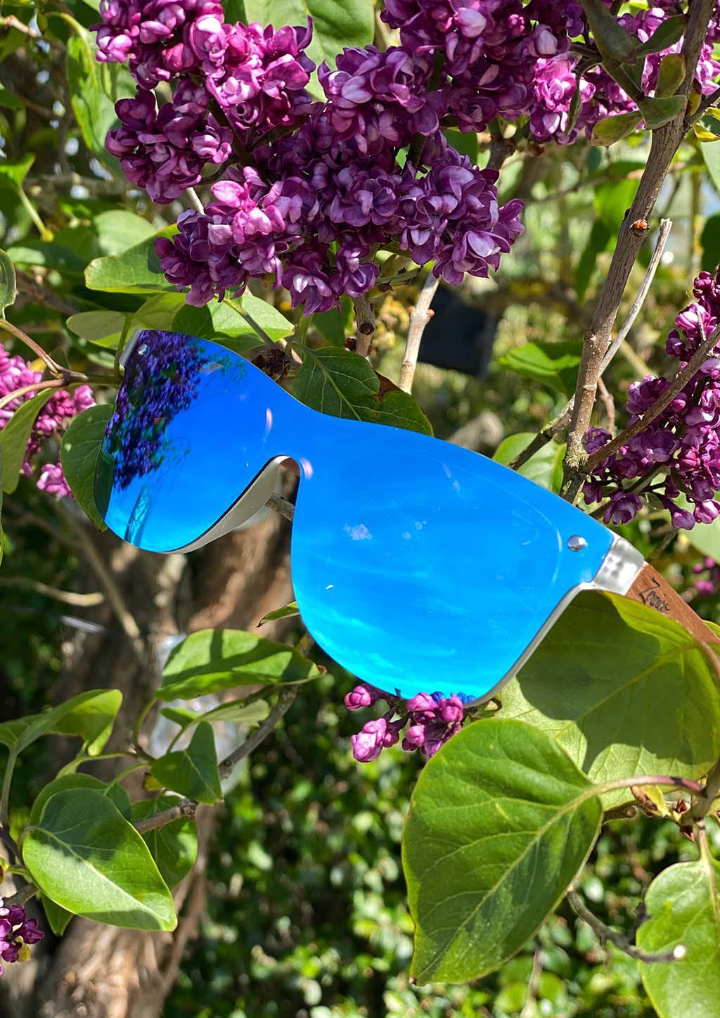 Eyewood Tomorrow - Gemeni wooden sunglasses featuring blue mirror polarized lenses and rosewood frame, displayed in an elegant empress tree case.