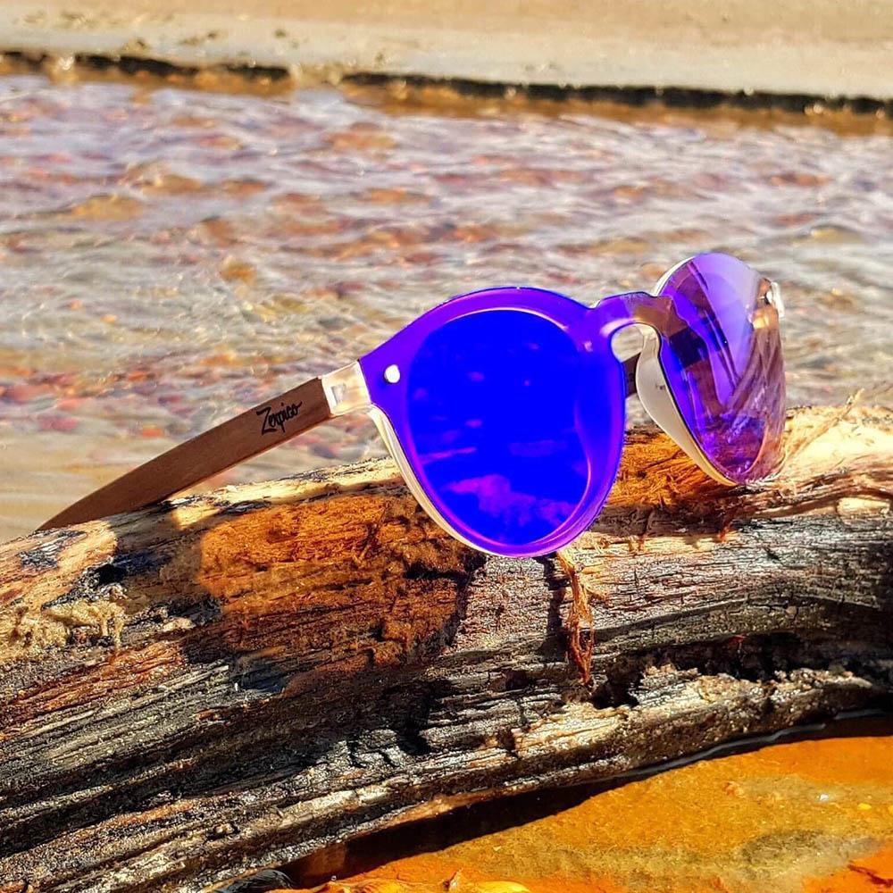 Eyewood Tomorrow - Lyra wooden sunglasses featuring purple polarized lenses and rosewood frame, displayed in an elegant empress tree case.