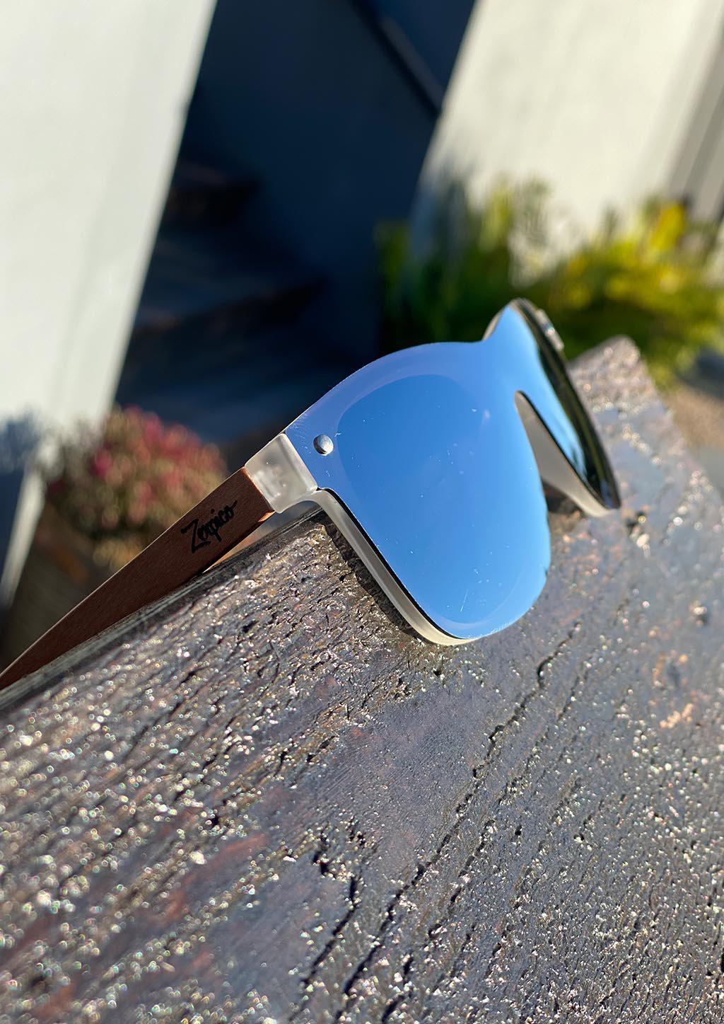 Eyewood Tomorrow - Perseus wooden sunglasses featuring rosewood frame and polarized silver mirror lenses, elegantly displayed in a case.