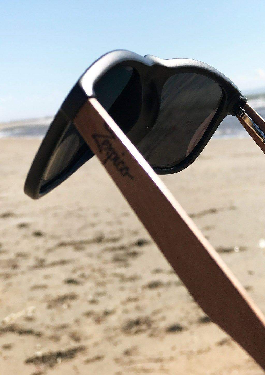 Eyewood Wayfarer sunglasses in Pitch Black with polarized lenses and rosewood frame, displayed in an elegant empress tree case.