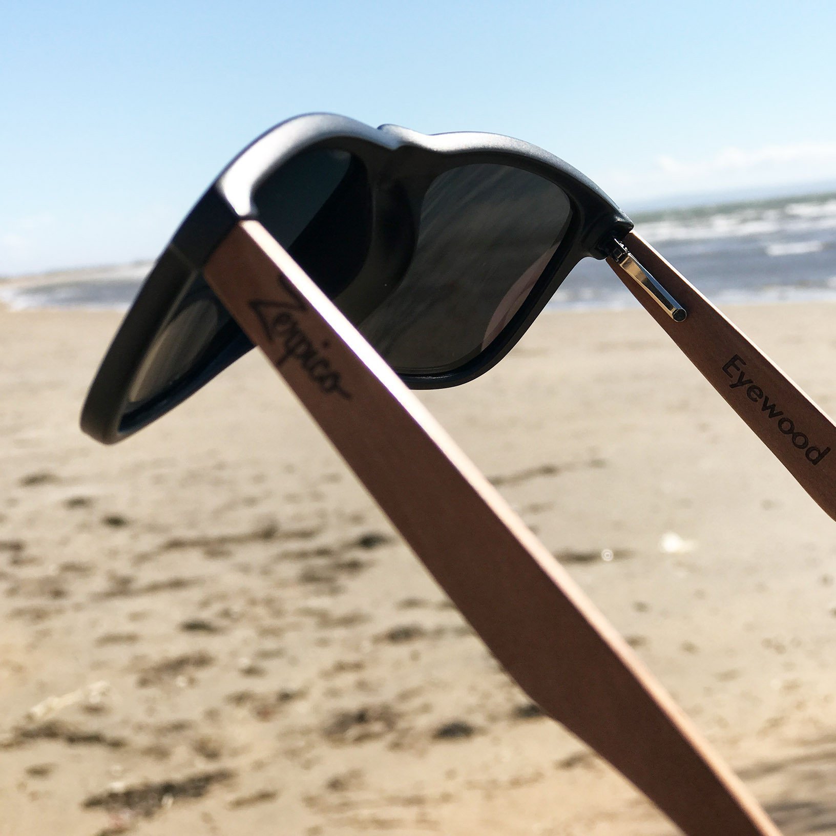 Eyewood Wayfarer sunglasses in Pitch Black with polarized lenses and rosewood frame, displayed in an elegant empress tree case.