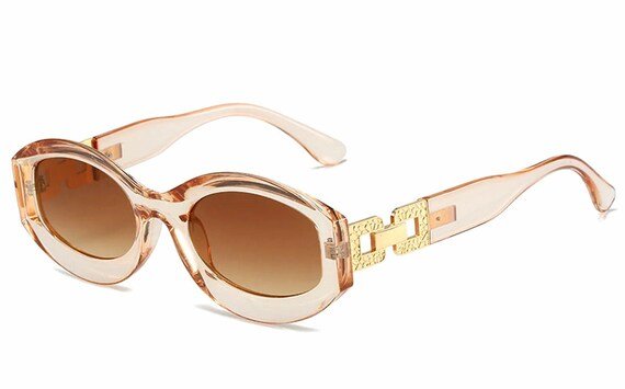 Gissel Sunglasses featuring stylish oval/round design with rich gold accents, displayed in multiple colors.