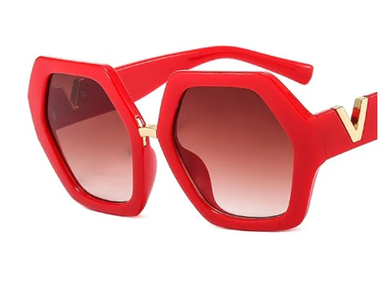 Glam Red Gold V Sunglasses featuring vibrant red frames and gold 'V' accent, displayed with a stylish leather case.