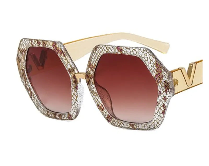 Glam Red Gold V Sunglasses featuring vibrant red frames and gold 'V' accent, displayed with a stylish leather case.