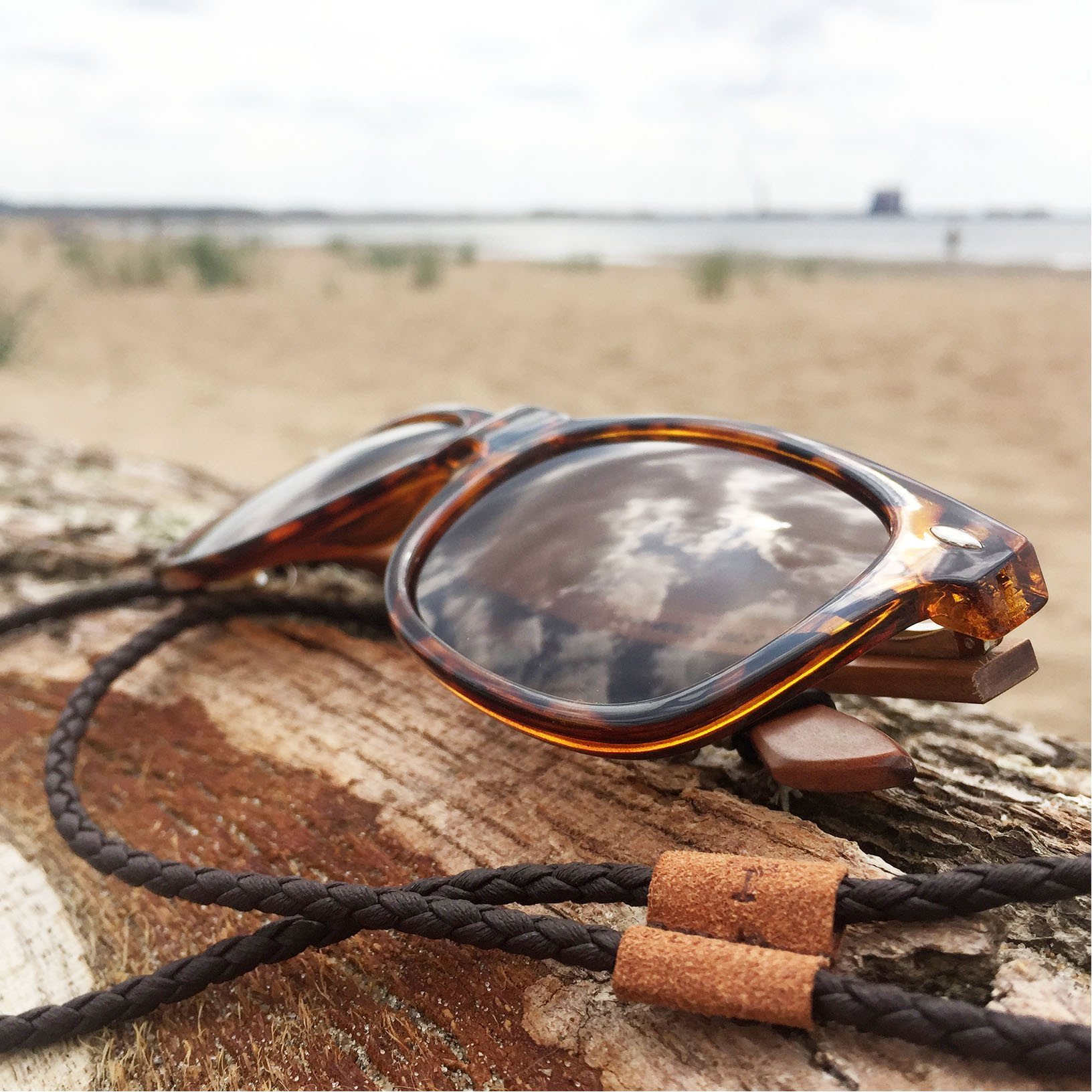 Brown braided leather safety strap for sunglasses, designed for comfort and style.