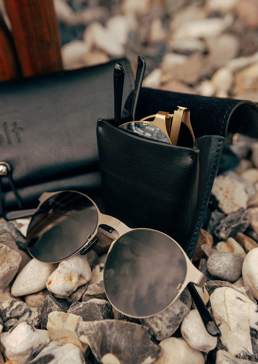 Looper foldable round sunglasses displayed with various frame colors and a stylish case.