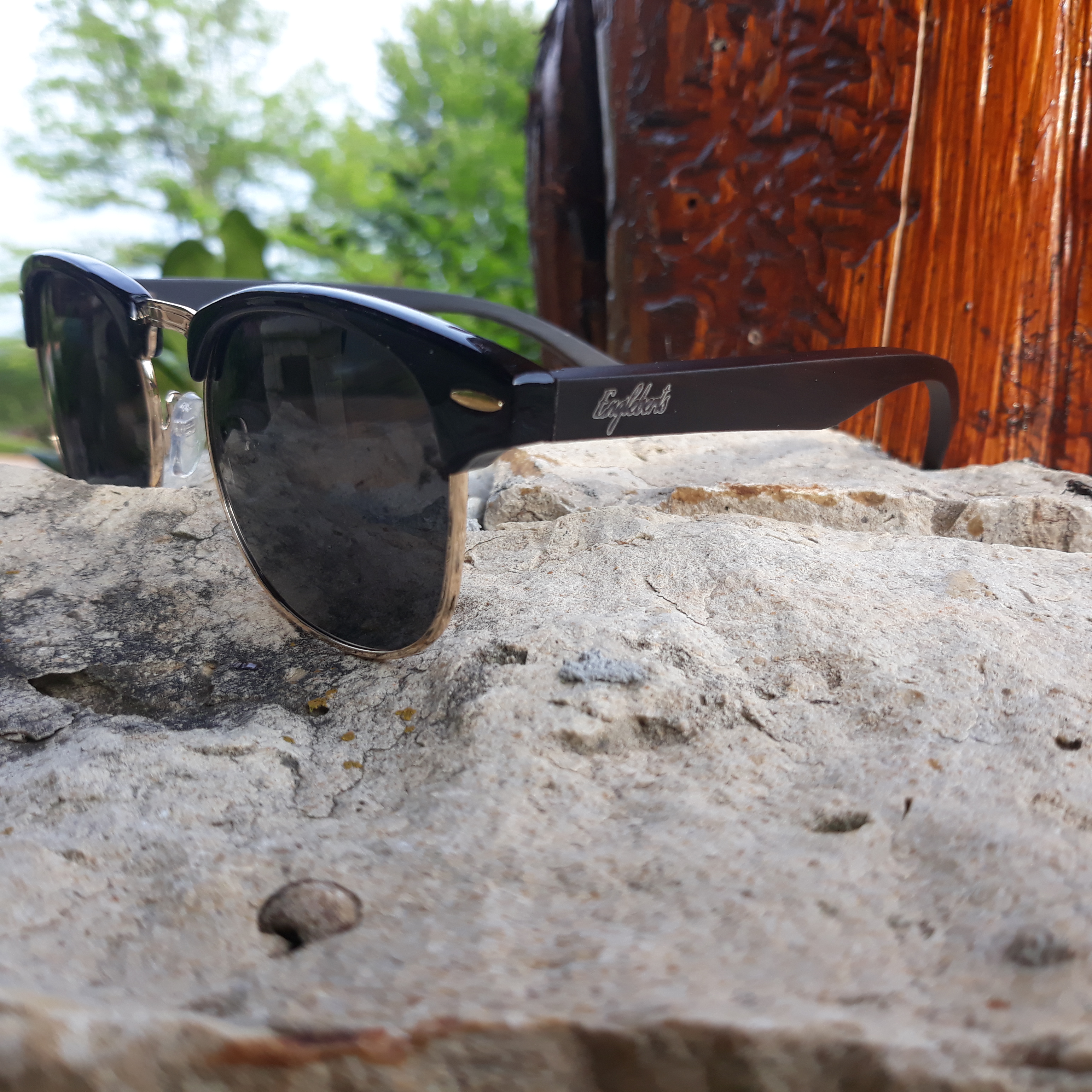 Midnight Black Bamboo Club Sunglasses displayed with a bamboo case, showcasing their handcrafted design and polarized lenses.