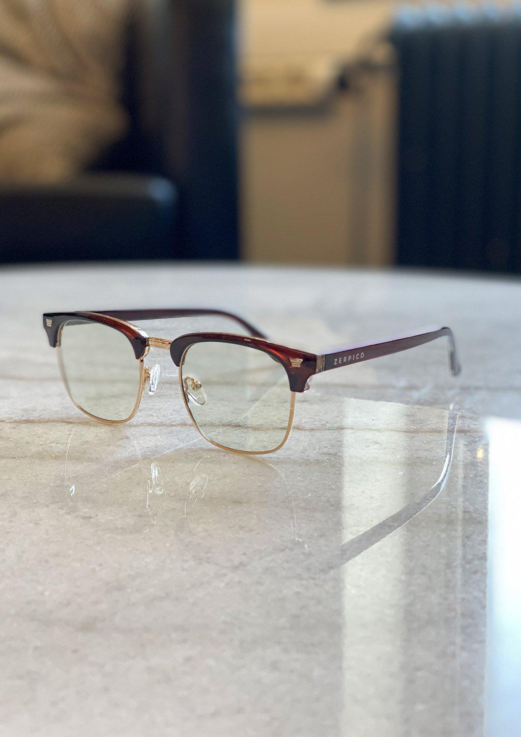 Nexus Ark blue-light glasses featuring a classic clubmaster design in black and gold.