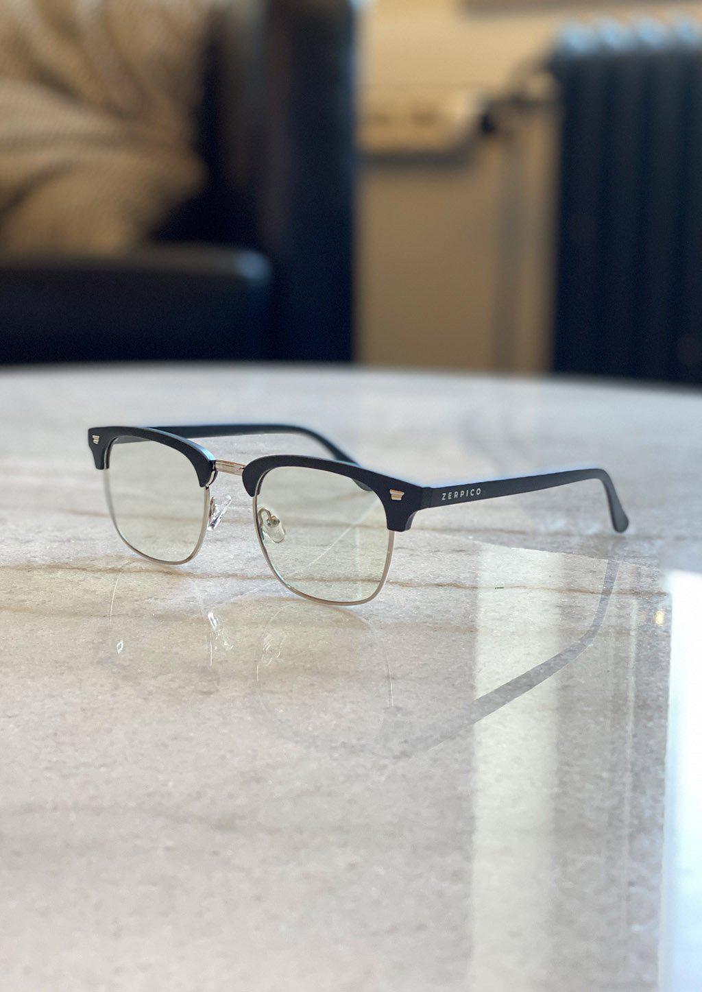 Nexus Ark blue-light glasses featuring a classic clubmaster design in black and gold.