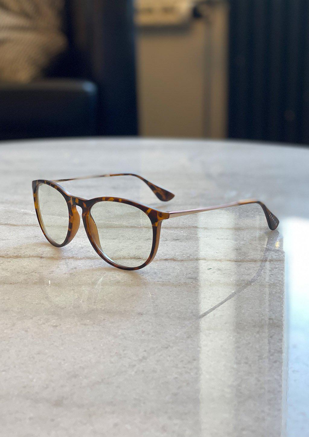 Nano anti blue-light glasses featuring a stylish cat-eye design, available in black, tortoise, and clear colors.