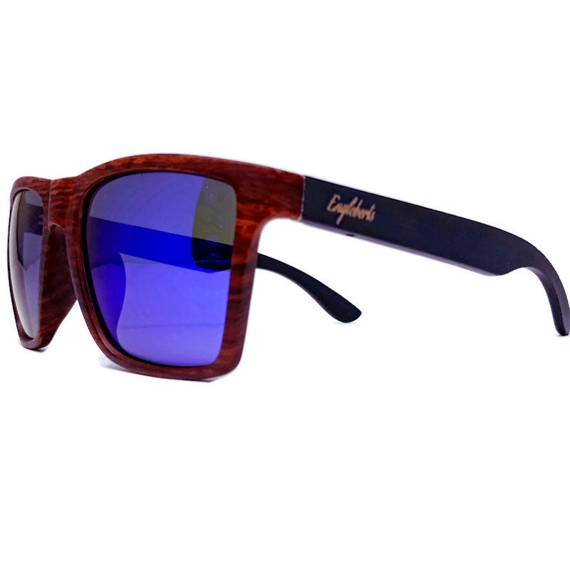 Stylish oak colored bamboo sunglasses with blue polarized lenses, displayed with a bamboo case and accessories.