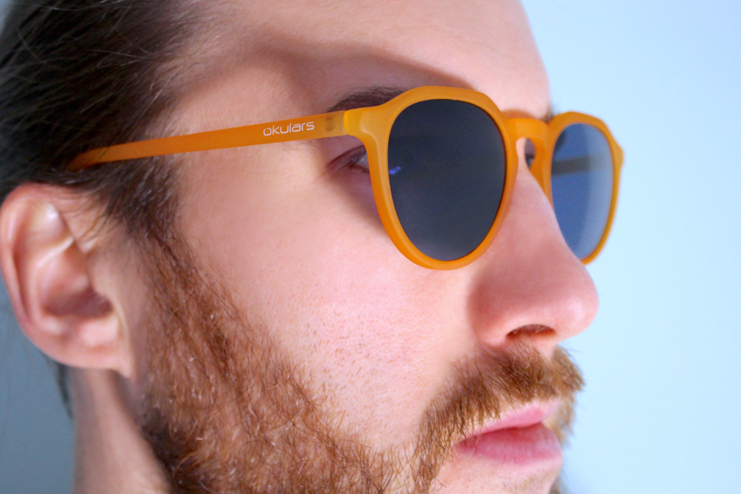 Okulars Eco Pacific Amber Blue sunglasses made from recycled materials, featuring a matte finish and UV400 lenses.