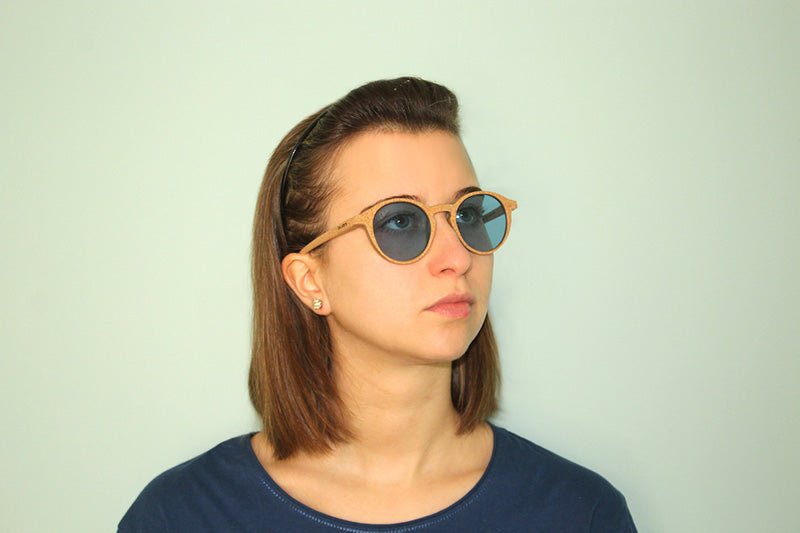 Okulars® Oak Still sunglasses with transparent blue lenses and natural cork frame, showcasing a stylish and lightweight design.