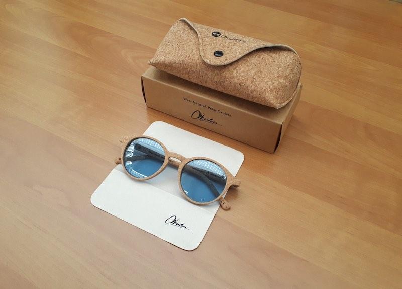 Okulars® Oak Still sunglasses with transparent blue lenses and natural cork frame, showcasing a stylish and lightweight design.