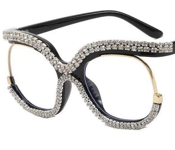 A pair of stylish Rhinestone Designer Frames featuring clear lenses and sparkling rhinestones, perfect for trendy eyewear.