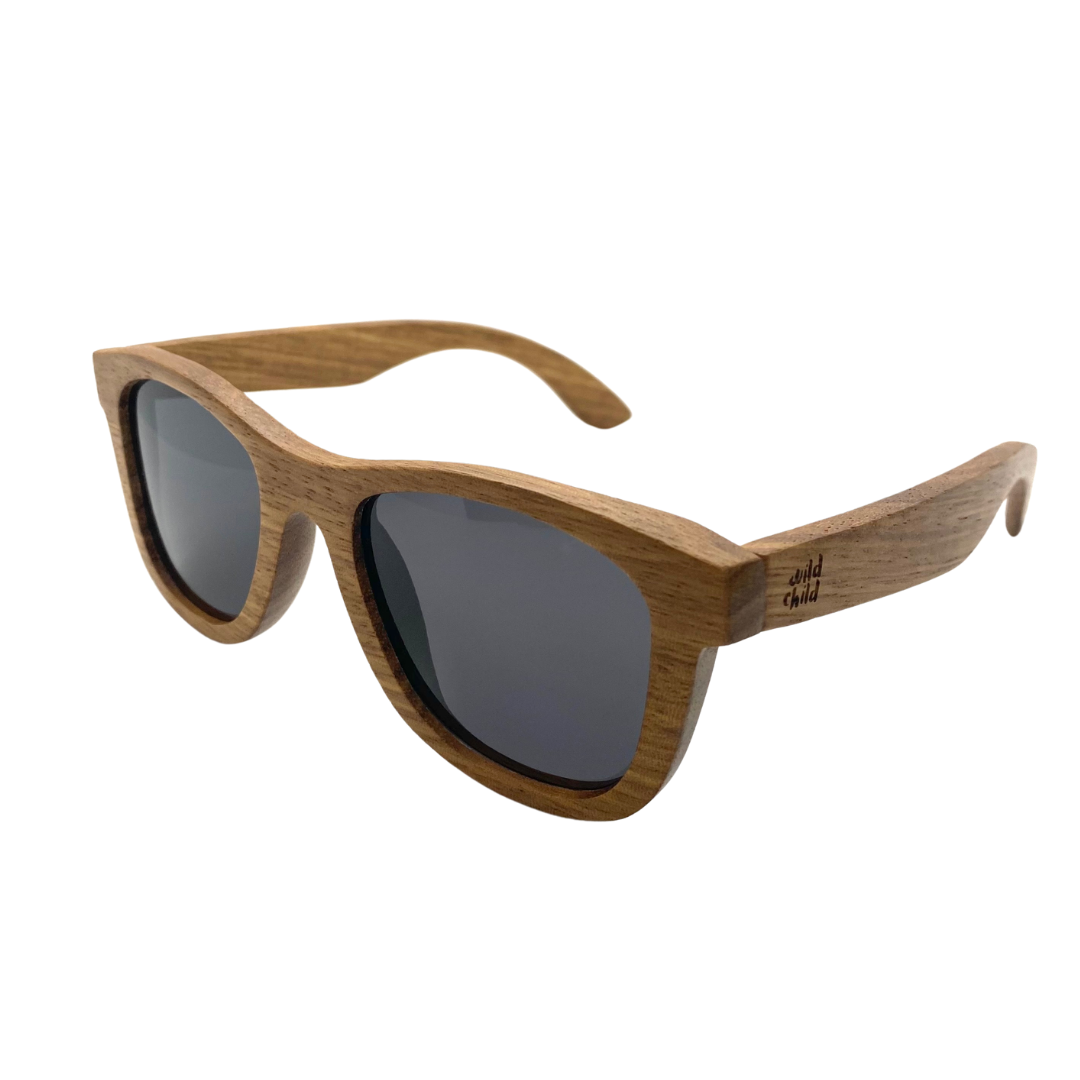 Stylish zebra wood sunglasses with black polarized lenses, designed for kids aged 3-8, floating on water.