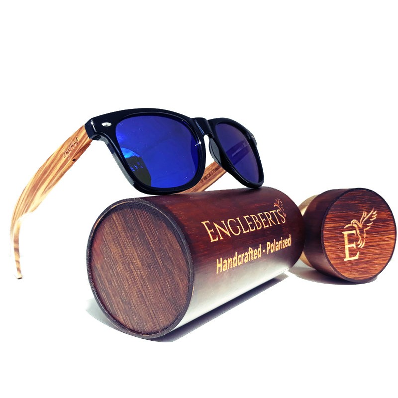 A pair of handcrafted zebrawood sunglasses featuring blue polarized lenses, displayed with a wooden case and accessories.