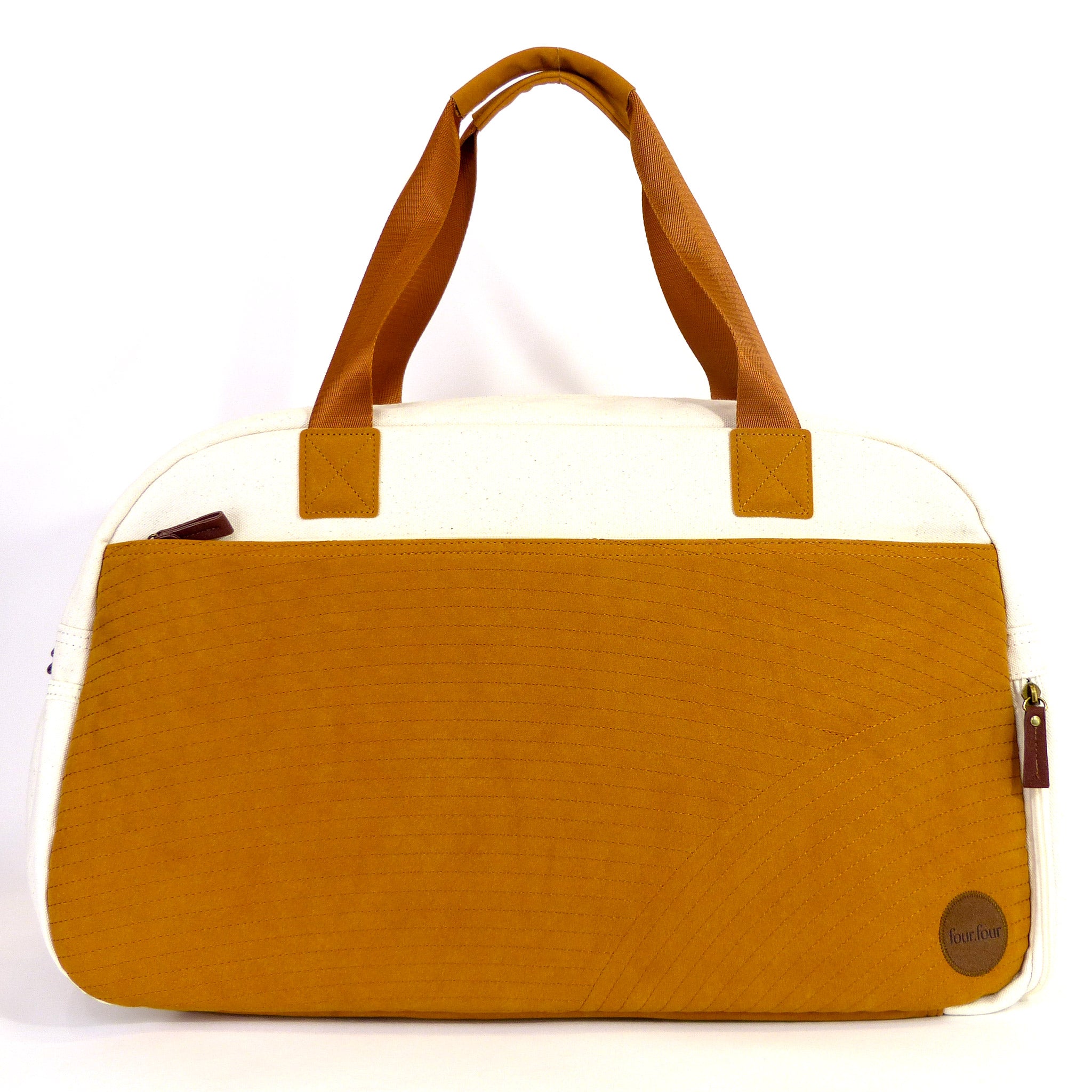 Getaway Duffel Bag in Bliss Curry and Cream color, showcasing its stylish design and spacious compartments for travel.