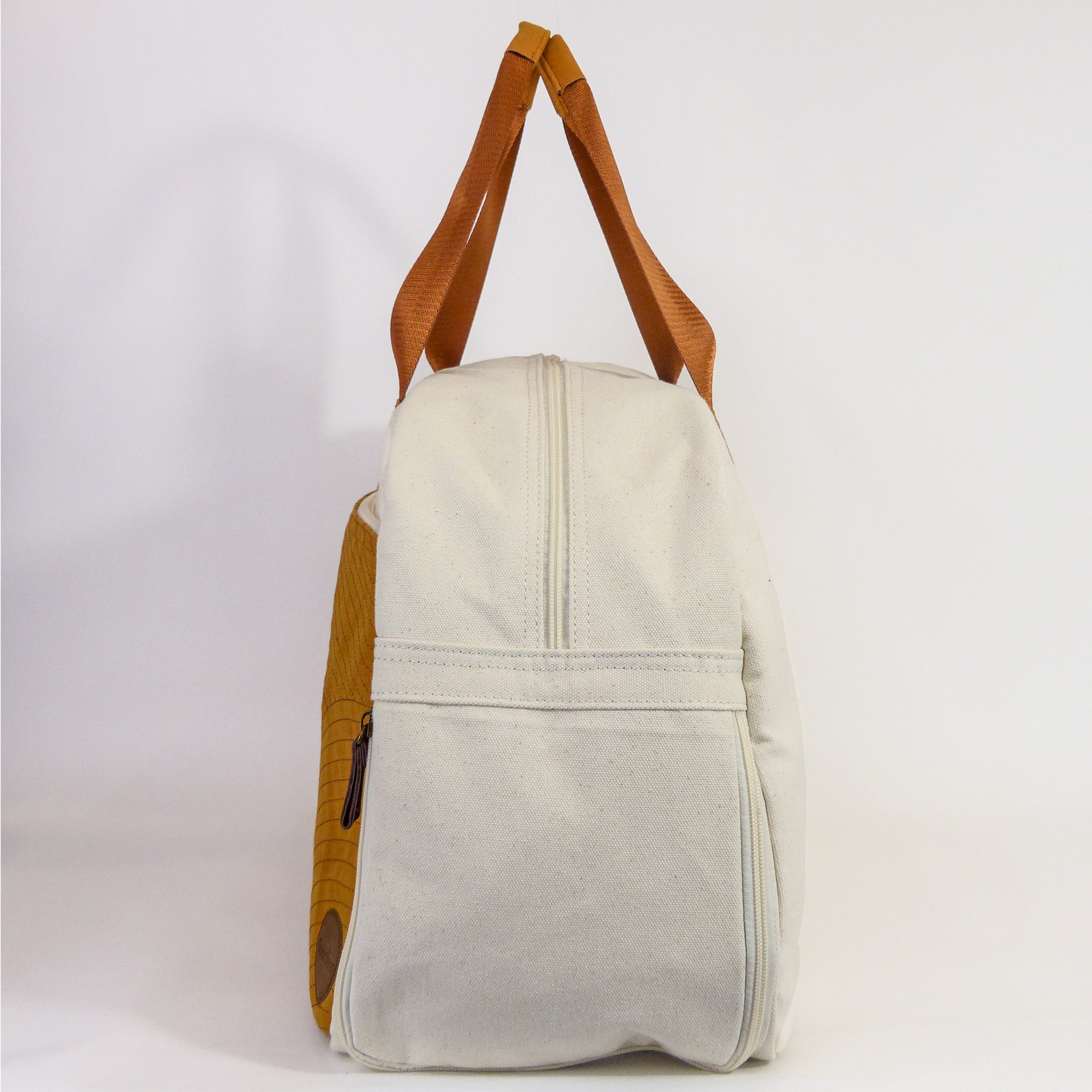 Getaway Duffel Bag in Bliss Curry and Cream color, showcasing its stylish design and spacious compartments for travel.