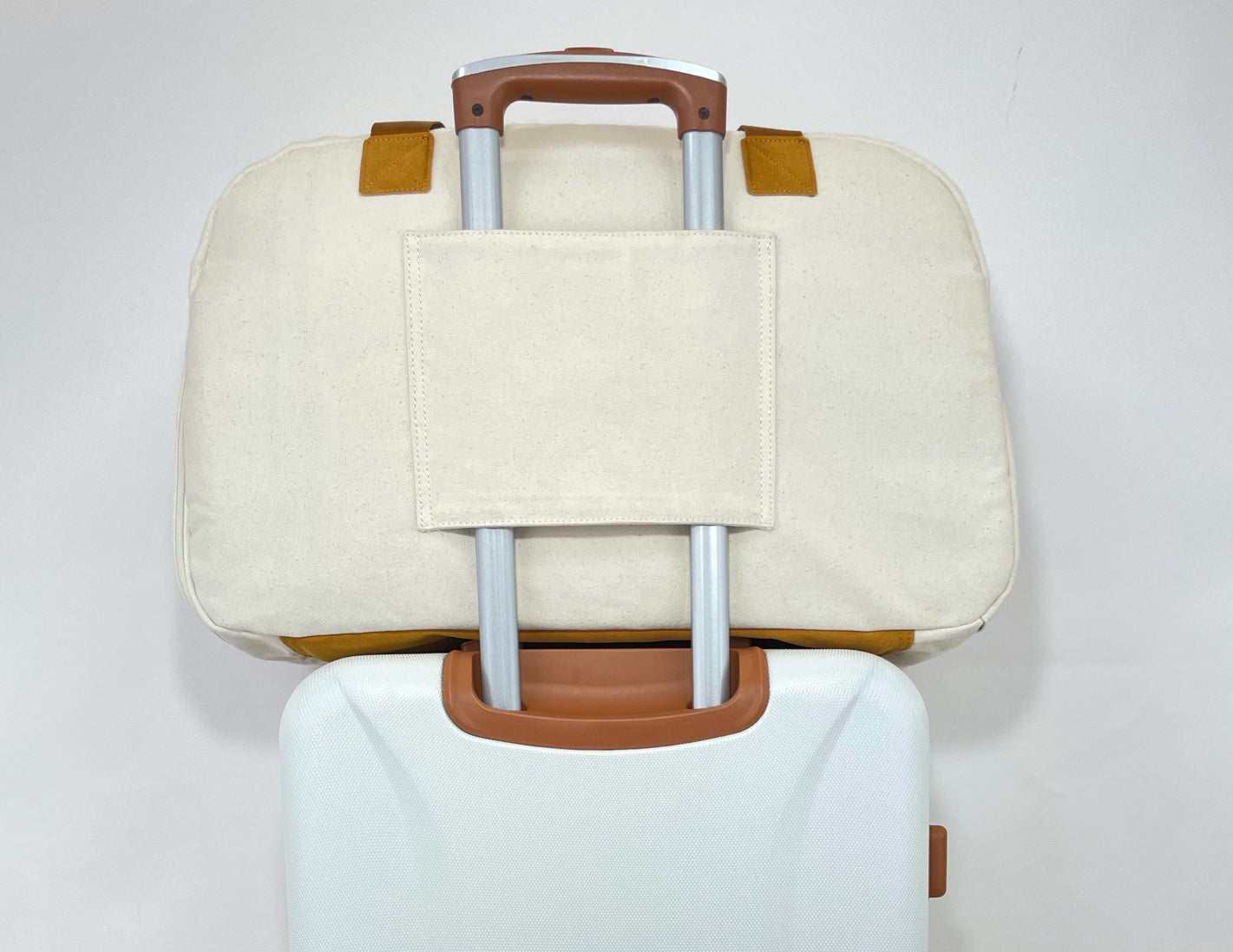 Getaway Duffel Bag in Bliss Curry and Cream color, showcasing its stylish design and spacious compartments for travel.