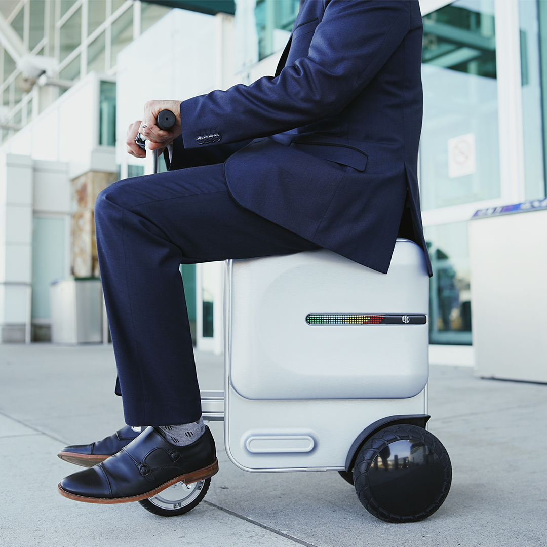 Smart Electric Suitcase Scooter with built-in saddle and large wheels, designed for easy airport travel.