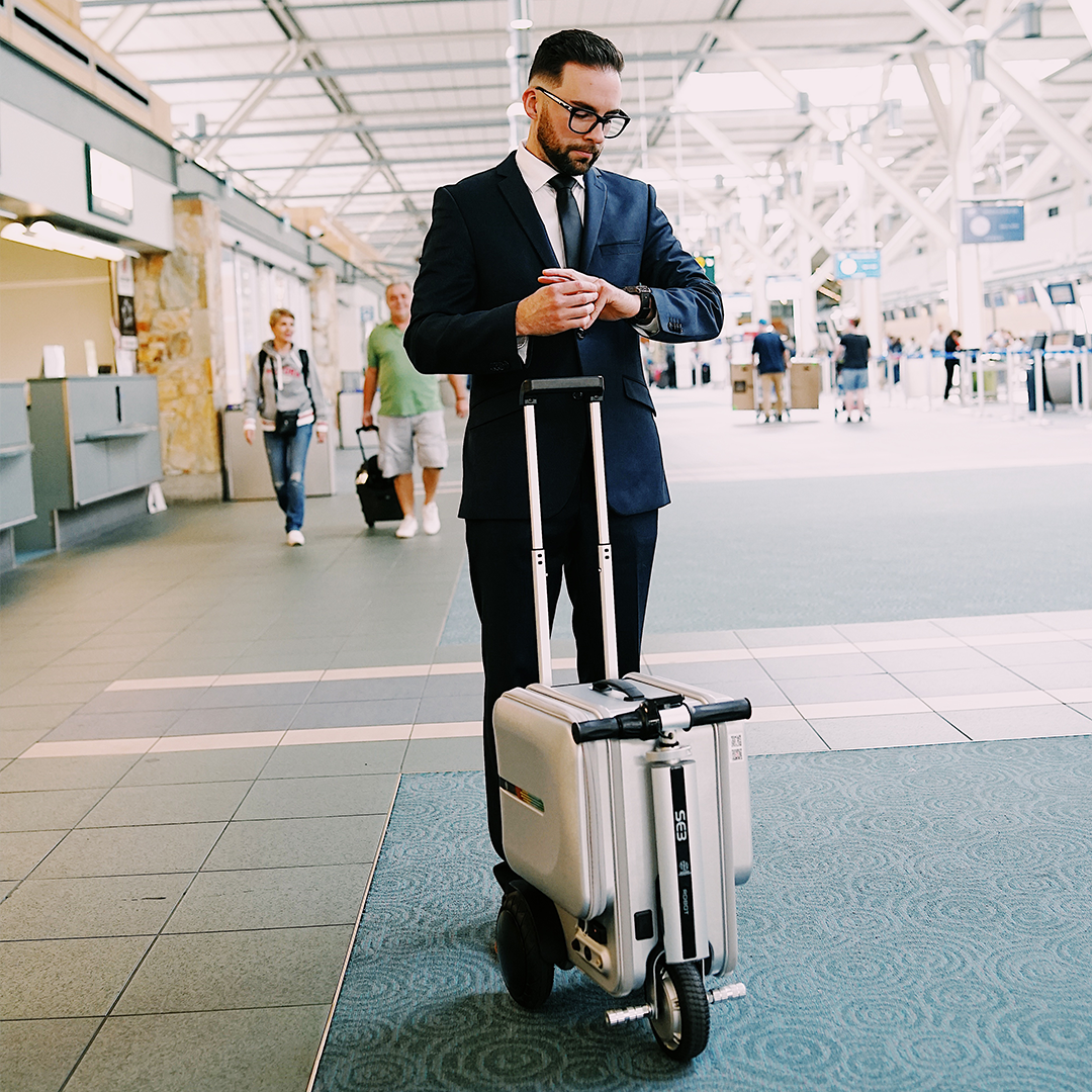 Smart Electric Suitcase Scooter with built-in saddle and large wheels, designed for easy airport travel.