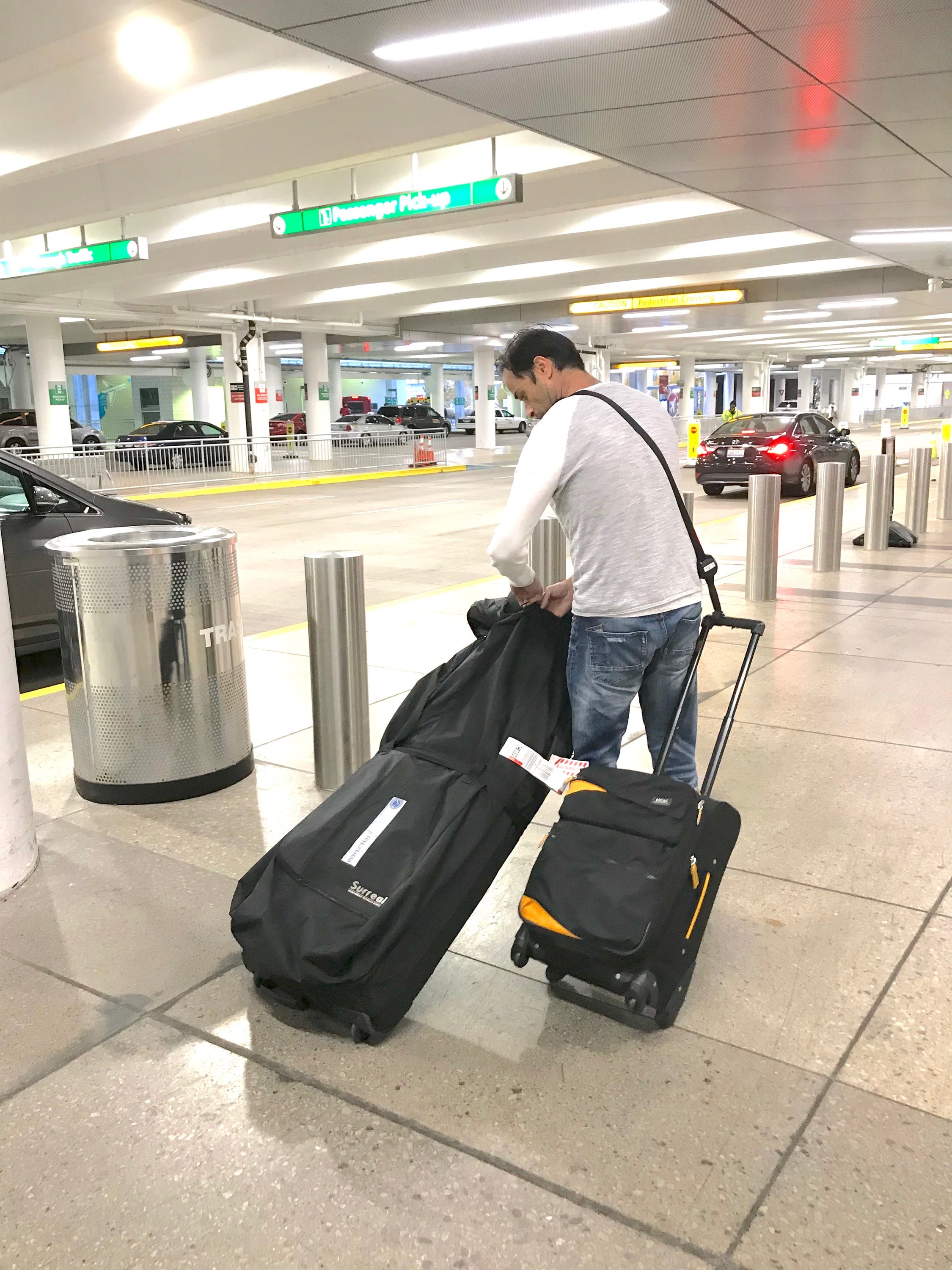 RetraStrap hands-free luggage strap attached to a wheeled carry-on, showcasing its ergonomic design and anti-theft features.