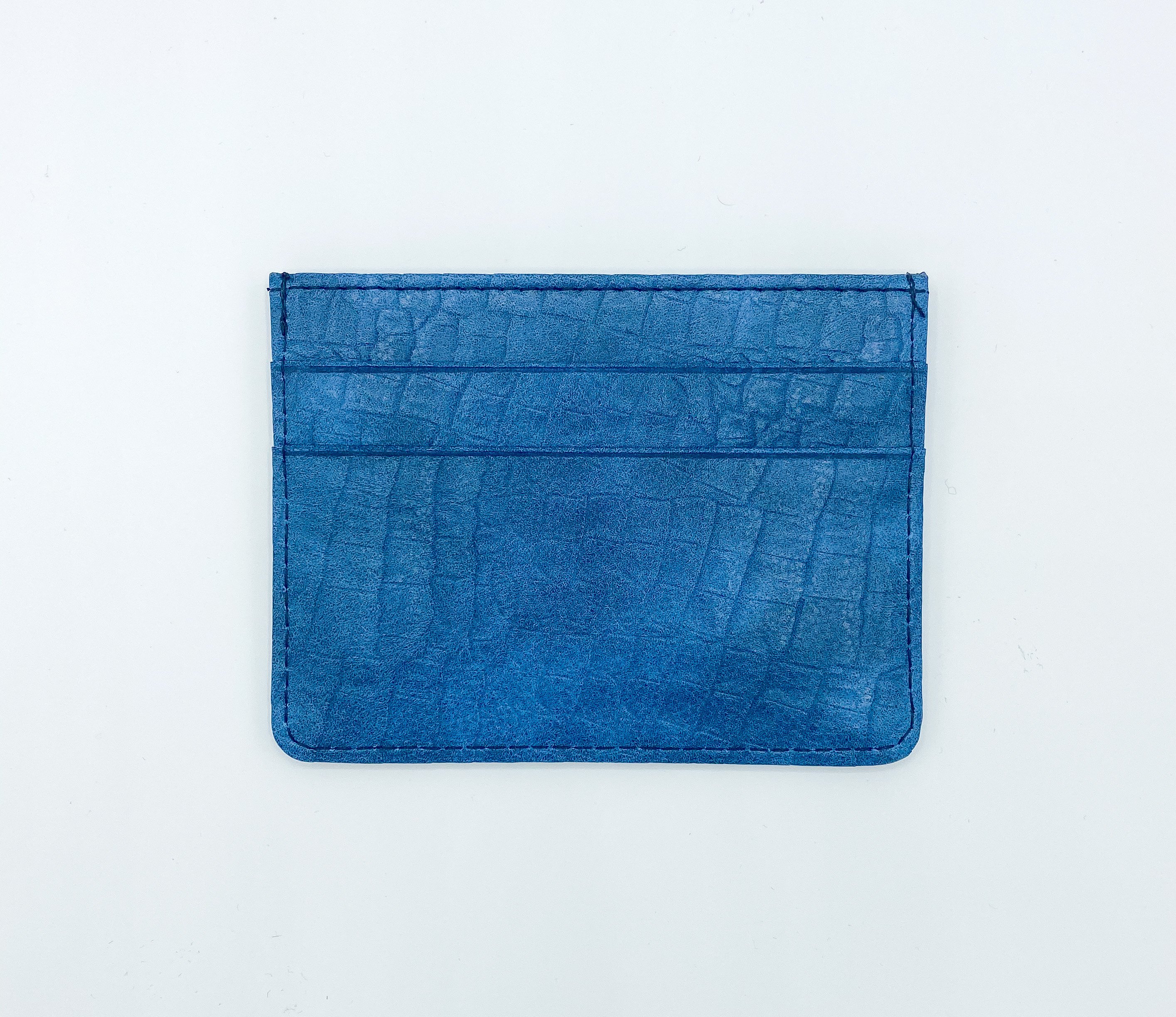 Crocodile Blue Card Case made of soft blue PU leather with silver foil logo, featuring five card slots and a sleek design.