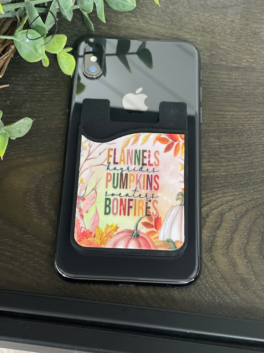 Flannels, Pumpkins, Bonfires Card Caddy Phone Wallet with microfiber screen cleaner attached, showcasing its compact design and seasonal theme.