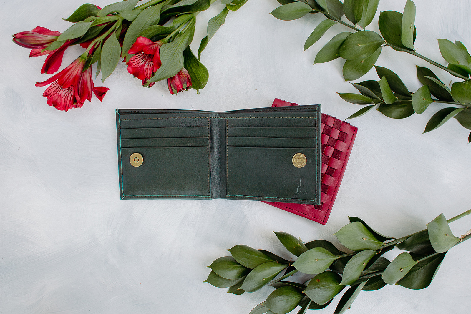 A stylish Leather Woven Bifold Wallet showcasing handwoven suede and smooth leather, featuring a magnetic bronze clasp and colorful cotton lining.