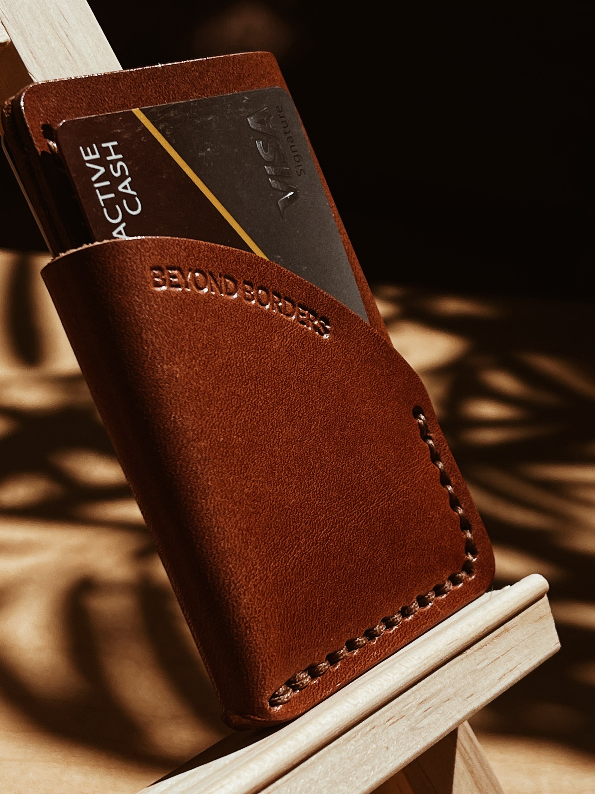 A handcrafted full-grain leather wrap wallet with three pockets, showcasing its elegant design and natural texture.