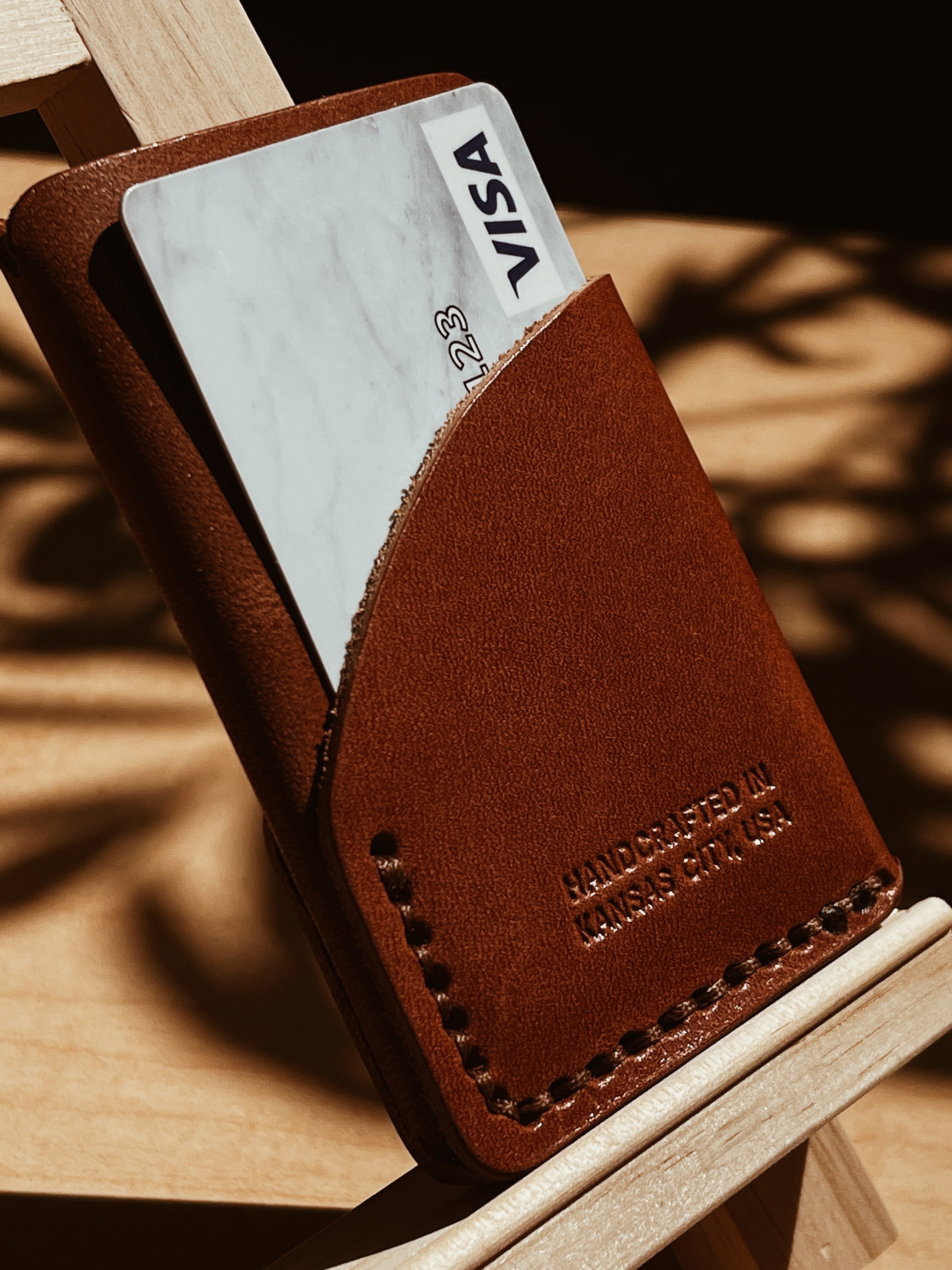 A handcrafted full-grain leather wrap wallet with three pockets, showcasing its elegant design and natural texture.