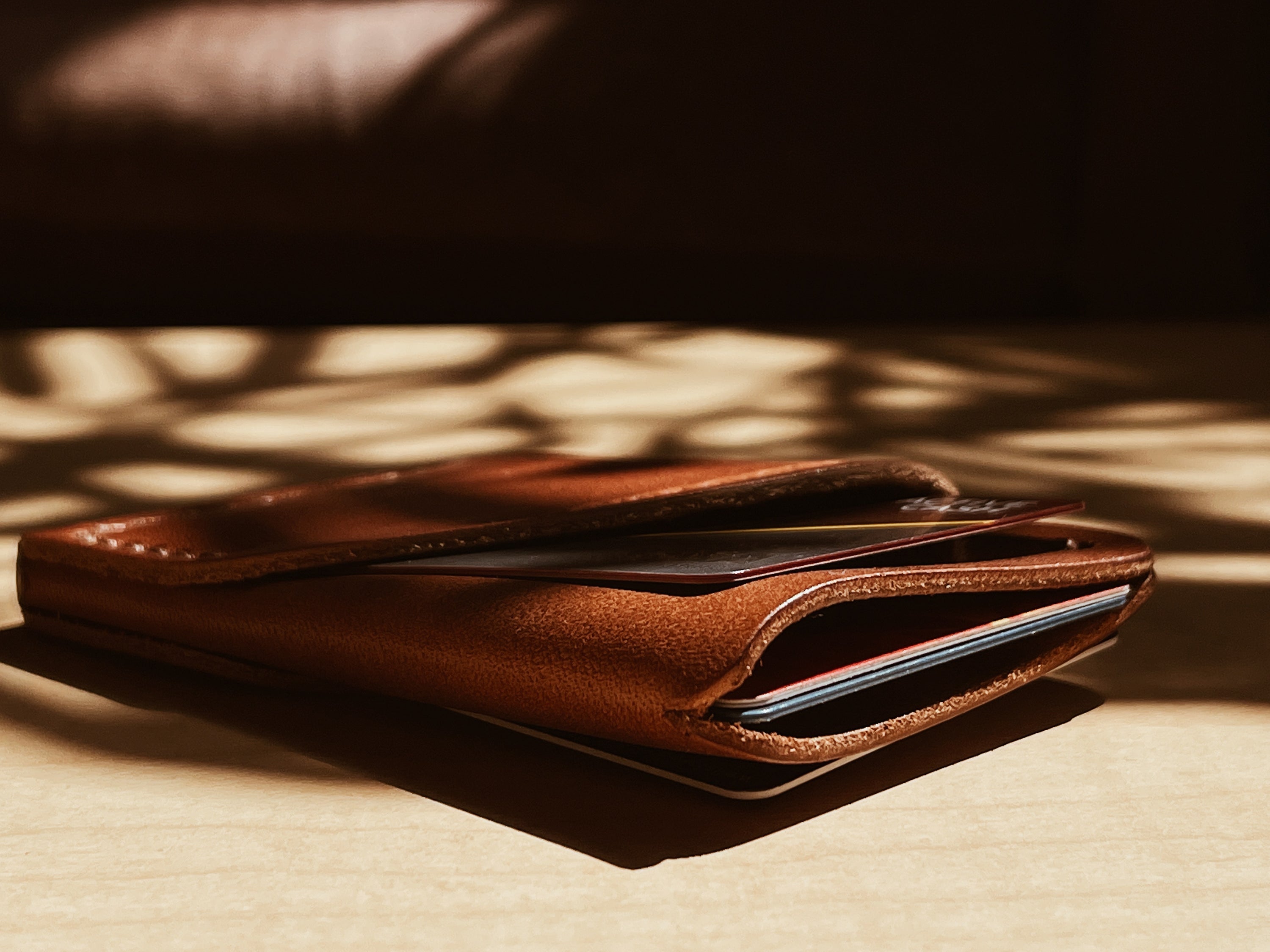 A handcrafted full-grain leather wrap wallet with three pockets, showcasing its elegant design and natural texture.