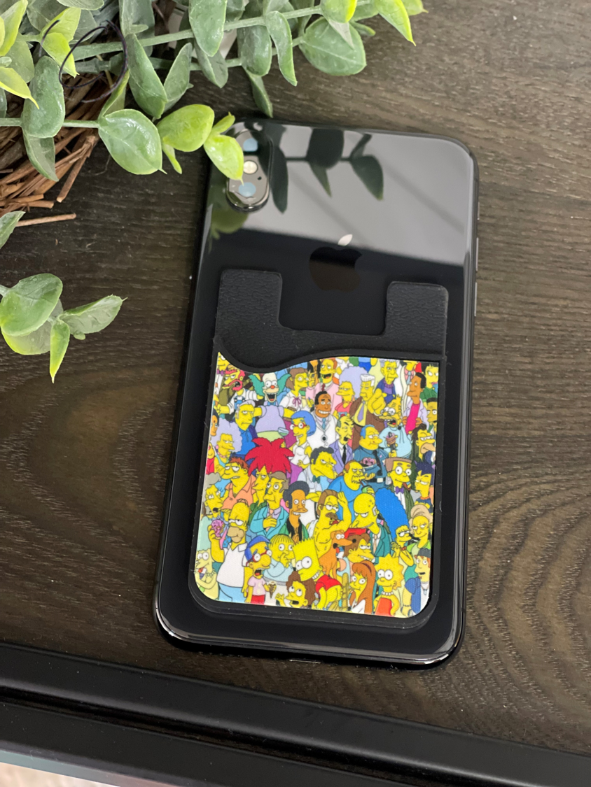 The Simpsons Card Caddy Phone Wallet featuring vibrant colors and characters, designed to hold cards and cash with a removable screen cleaner.