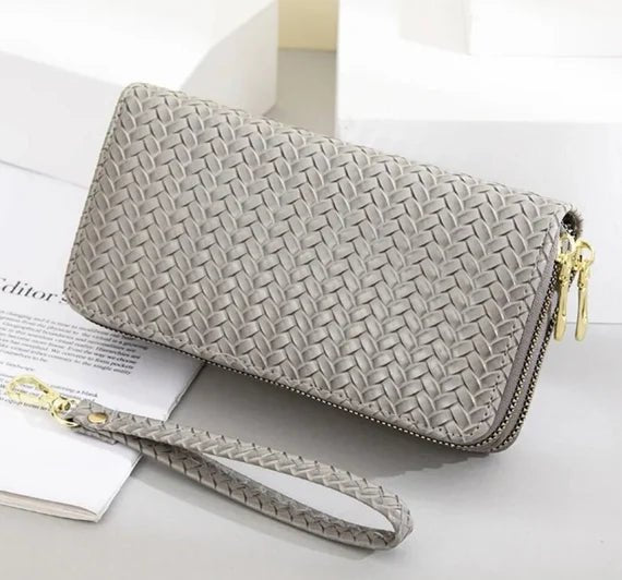 A stylish weaved designer wallet for women, showcasing multiple compartments and available in various colors.