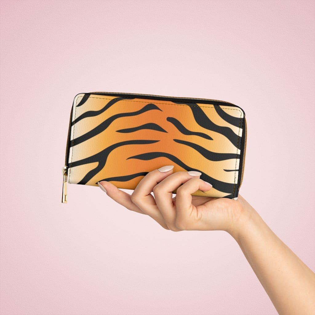 Stylish women's zip wallet in orange and black tiger stripe design, showcasing its faux leather material and zipper closure.