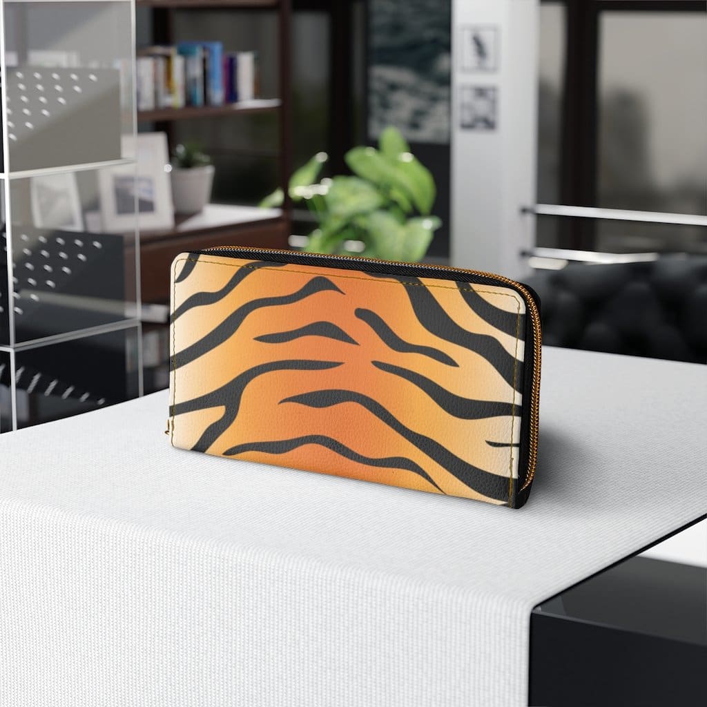 Stylish women's zip wallet in orange and black tiger stripe design, showcasing its faux leather material and zipper closure.