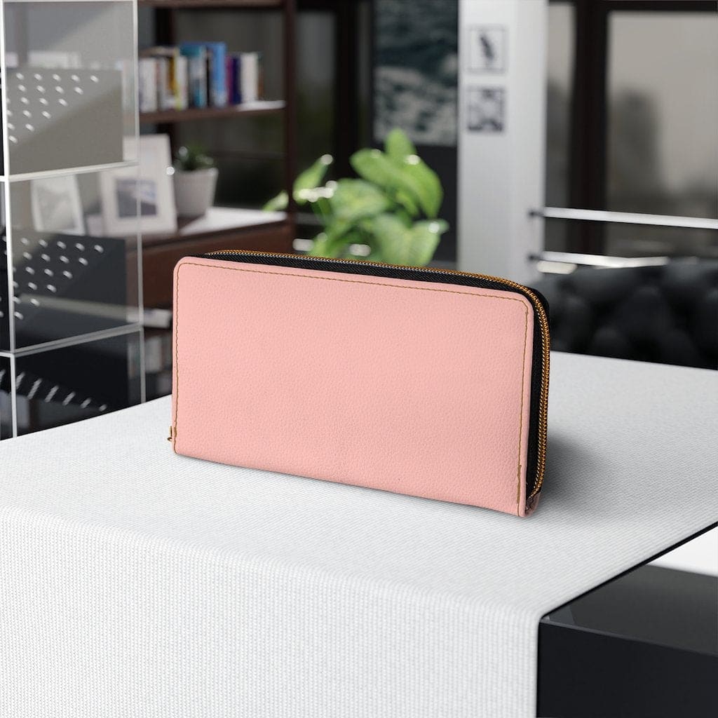 Pastel peach women's zip wallet made of faux leather with multiple pockets and gold stitching.